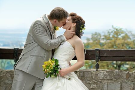 Elegant bride and groom posing together outdoors on a wedding day の写真素材