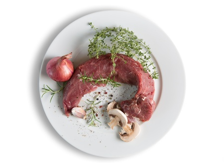 Pork mea  - Tenderloin on a plate with spices and herbsの写真素材