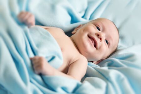 Newborn baby on blue blanketの写真素材