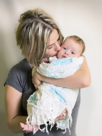 Beautiful baby of three months old in his mother's handsの写真素材