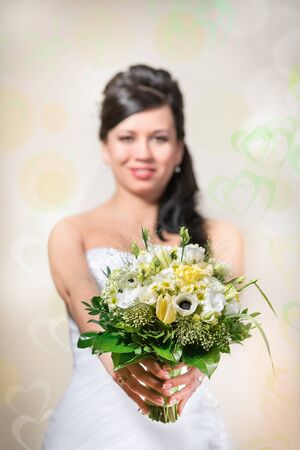 Beautiful bride with bouquet - focus on bouquetの写真素材