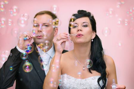 The bride and groom to blow a bubble blowerの写真素材