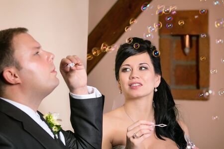 The bride and groom to blow a bubble blowerの写真素材