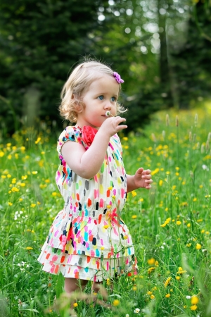 Little girl with daisy flower in handの写真素材