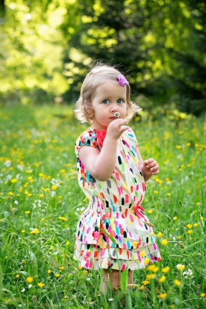 Little girl with daisy flower in handの写真素材