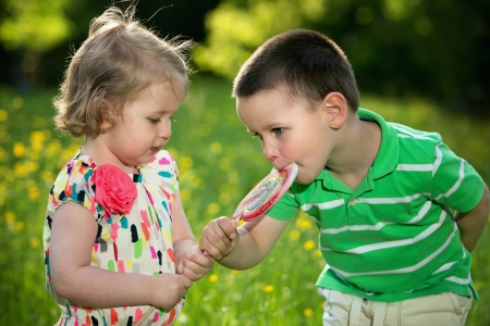 Sweet siblings with big lollipopの写真素材