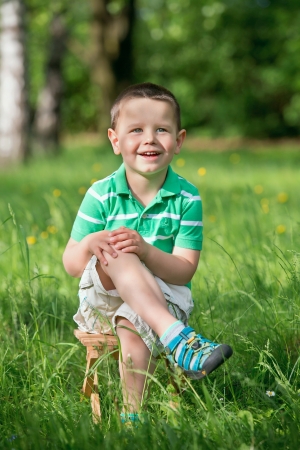 Portrait of a happy little boy in the park の写真素材