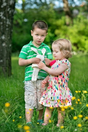 Brother and sister playing in the gardenの写真素材