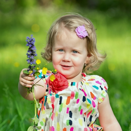 Little girl with flower in handの写真素材