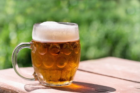 Glasses of beer on a wooden table  の写真素材