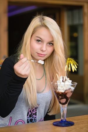 Young pretty girl eating chocolate ice creamの写真素材