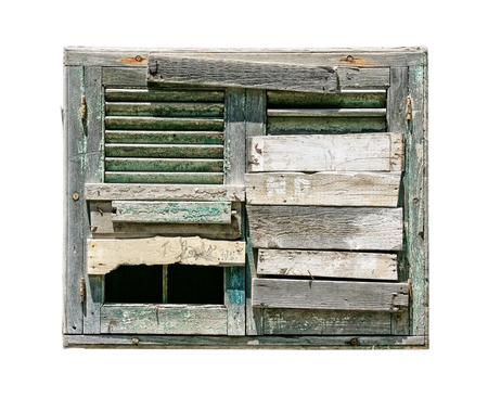 window in an old house with boarded up on white backgroundの写真素材