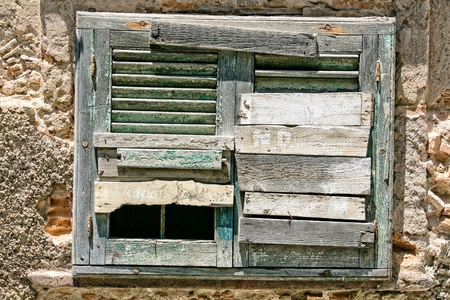 Window in an old house with boarded up の写真素材