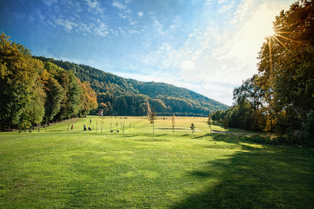 Beautiful golf course in against the lightの写真素材