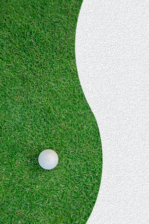 White golf ball on green grass backgroundの写真素材