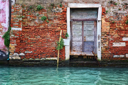 Old door and brick wall in Veniceの写真素材