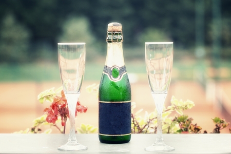detail on a bottle of champagne with free space for inscription and two glassesの写真素材