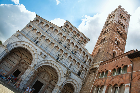 LUCCA, ITALY - June 30: Tourists at Church San Martino in Lucca Italy.People wait outside the Church Santa Maria Forisportam in Lucca Italy. They are huddled around a guide listening on June 30, 2014のeditorial素材