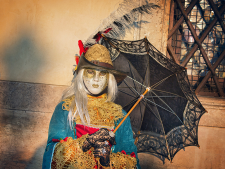 VENICE, ITALY - FEBRUARY 27, 2014: Unidentified person with Venetian Carnival mask in Venice, Italy on February 2014. In 2014 was the Venetian Carnival held between 15 February and 4 marchのeditorial素材