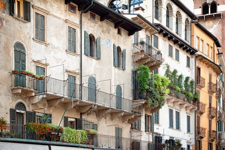 Beautiful balcony with flowers draping over the edge in Italy.の写真素材