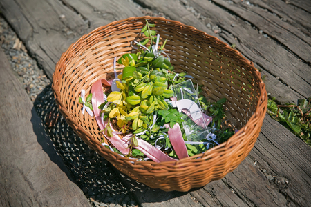 Wicker basket with twigs, ribbon and pinsの写真素材