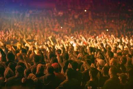 Crowd at a music concert, audience raising hands up の写真素材