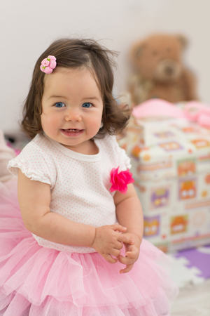Baby in a dress, in a pink skirt. Birthday, one yearの写真素材