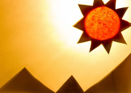 The Shadow of sun and mountains made of recycled paper.の写真素材