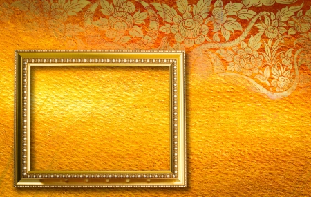Gold picture frame on the golden thai pettern.の写真素材