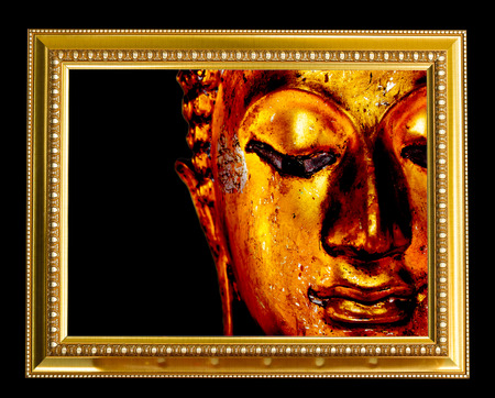 Buddha face in gold frame.