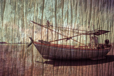 Fishing boat beached on grunge background.の写真素材