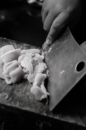 People are using a knife sliced pork for cooking.の写真素材