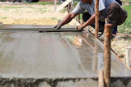 Workers are plastered concrete in the sun.の写真素材