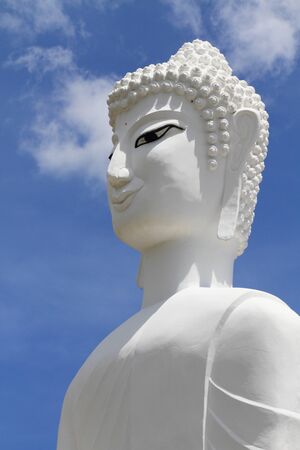 A statue of of a white Buddha in Thailand.の写真素材