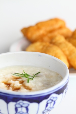 asian style rice soup with herbs in a bowl