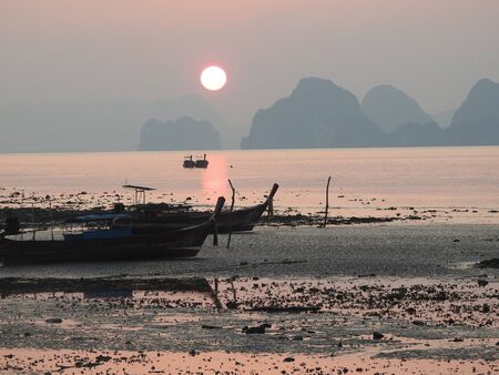 local fishing boat at on sunrise in Phang-Nga,Thailandの写真素材