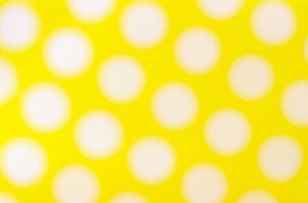 Blurred  Seamless pattern with big white polka dots on a sunny yellow use a backgroundの写真素材