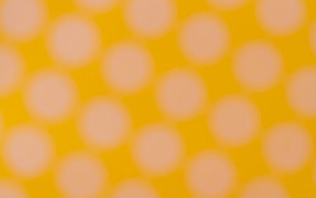 Blurred  Seamless pattern with big white polka dots on a sunny yellow use a backgroundの写真素材