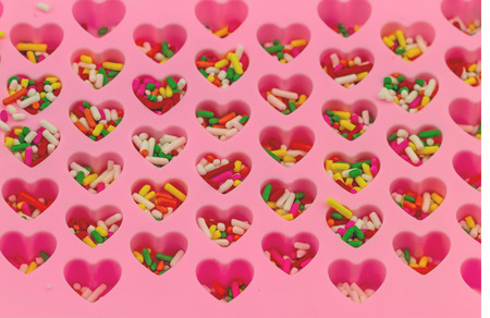 Many chocolate drops in pink heart  shape jellyの写真素材