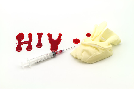 Blood in  syringe and  glove hand  on A word  HIV  background