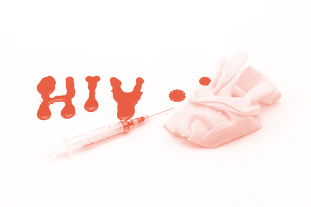 Blood in  syringe and  glove hand  on A word  HIV  backgroundの写真素材