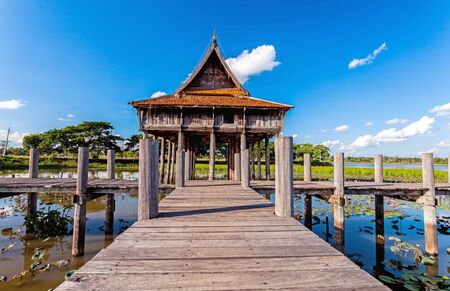 Wooden bridge at Thai wooden temple architecture on Park NongKhulu in UbonRatchathani province, Thailandの写真素材