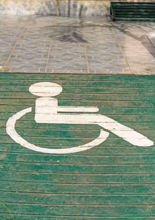 Handicapped sign on Rusty Surface of old Checkered Plateの写真素材