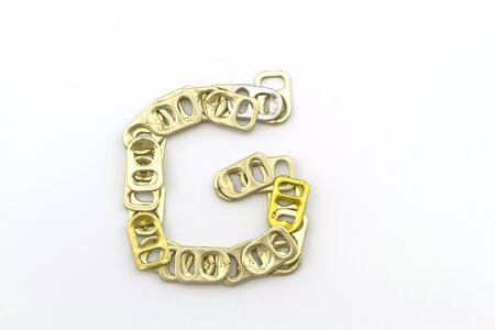 Alphabet  of G stack from  ring pull aluminum of cans on white backgroundの写真素材