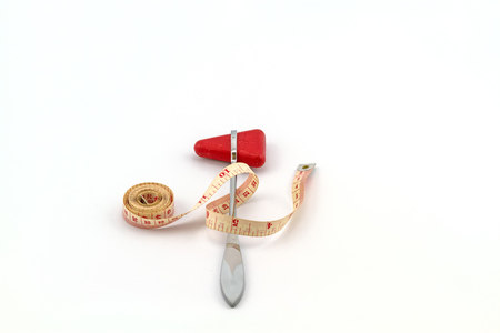 Pink tape measuring and knee jerk medical object  on white backgroundの写真素材