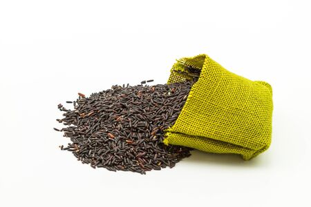 Rice berry in green sisal sack on white backgroundの写真素材