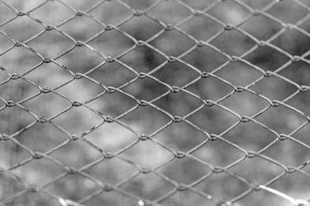 wire fence on brown cement backgroundの写真素材