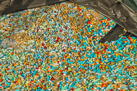 Many colorful medicines expire in black plastic bag