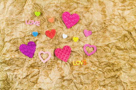 Colorful of heart-shape from paper cut on paper sheet grunge texture