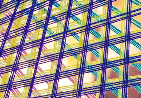 Colorful holy thread crochet pattern, a white string held by Buddhist priests while chanting or put around a house to keep off evil spiritsの写真素材